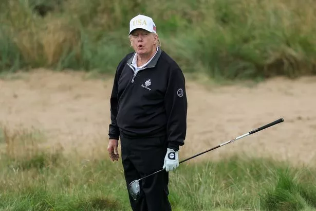 Donald Trump holds a driver in Scotland 