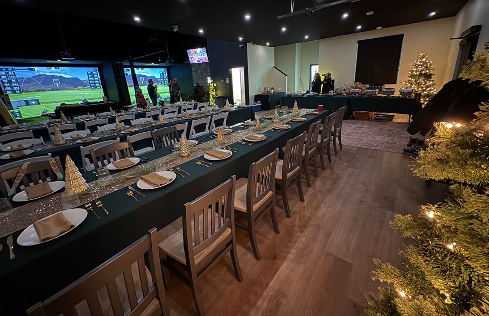 a banquet set up at a golf simulator