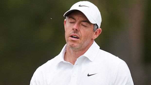 Rory McIlroy of Northern Ireland reacts after playing a shot on the fourth hole during the first round of the Australian Open golf tournament in Melbourne, Australia, Thursday, Dec. 4, 2025. (AP Photo/Asanka Brendon Ratnayake)