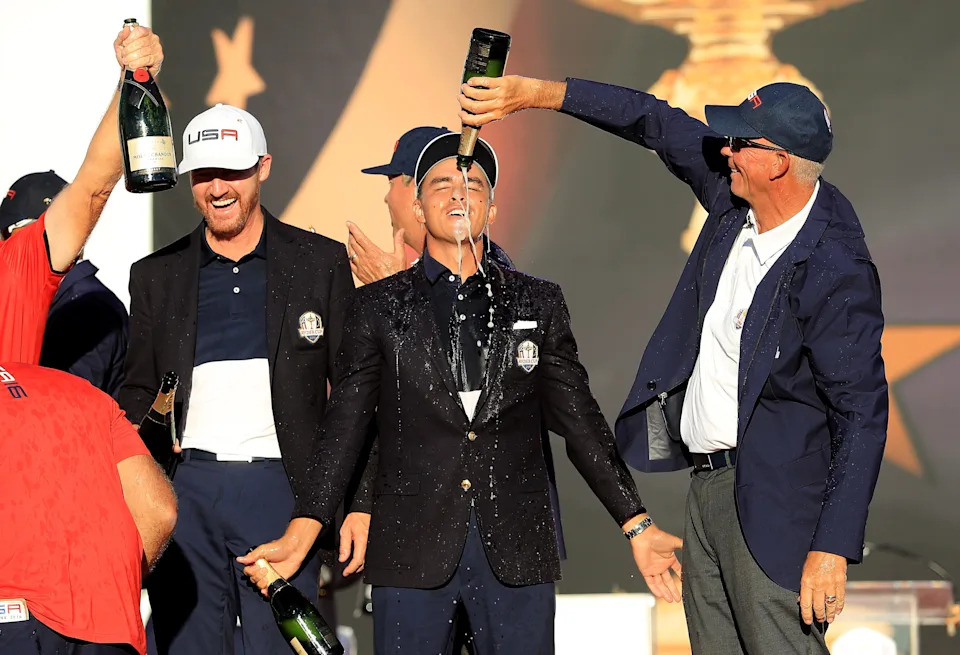 Vice-captain Tom Lehman pours champagne on Rickie Fowler during the closing ceremony of the 2016 Ryder Cup at Hazeltine National Golf Club on October 2, 2016 in Chaska, Minnesota.