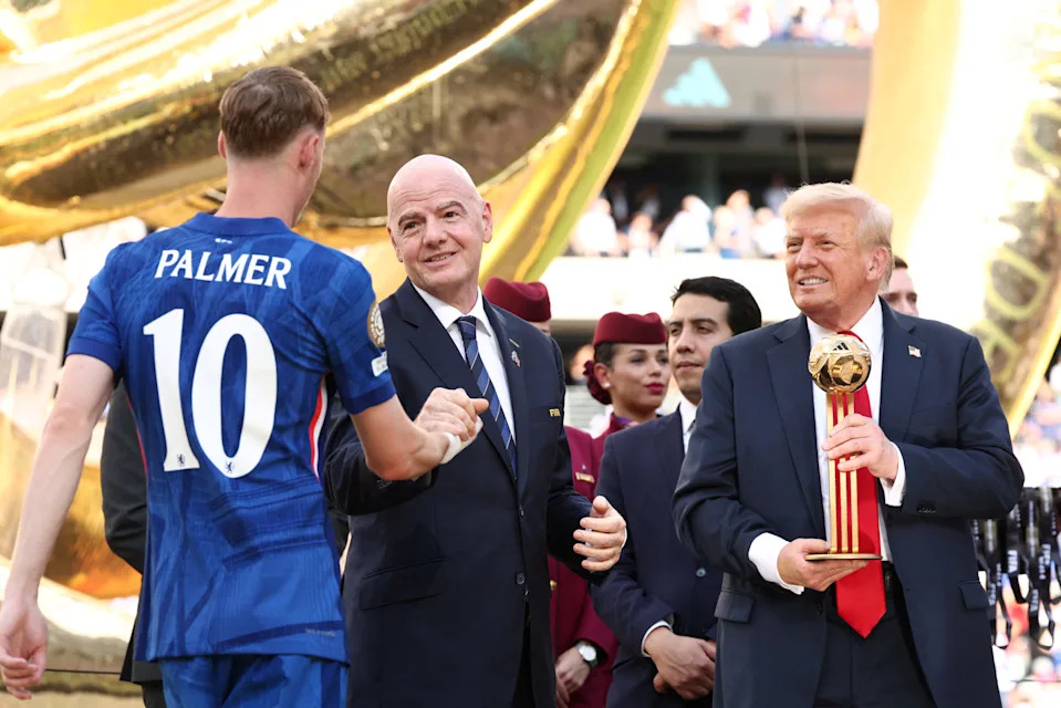 U.S. President Donald Trump holds the golden ball trophy as Chelsea's Cole Palmer greets FIFA president Gianni Infantino after Chelsea won against Paris St Germain in the FIFA Club World Cup final, at the MetLife Stadium in East Rutherford, New Jersey, U.S., July 13, 2025. REUTERS/Kevin Lamarque/Pool