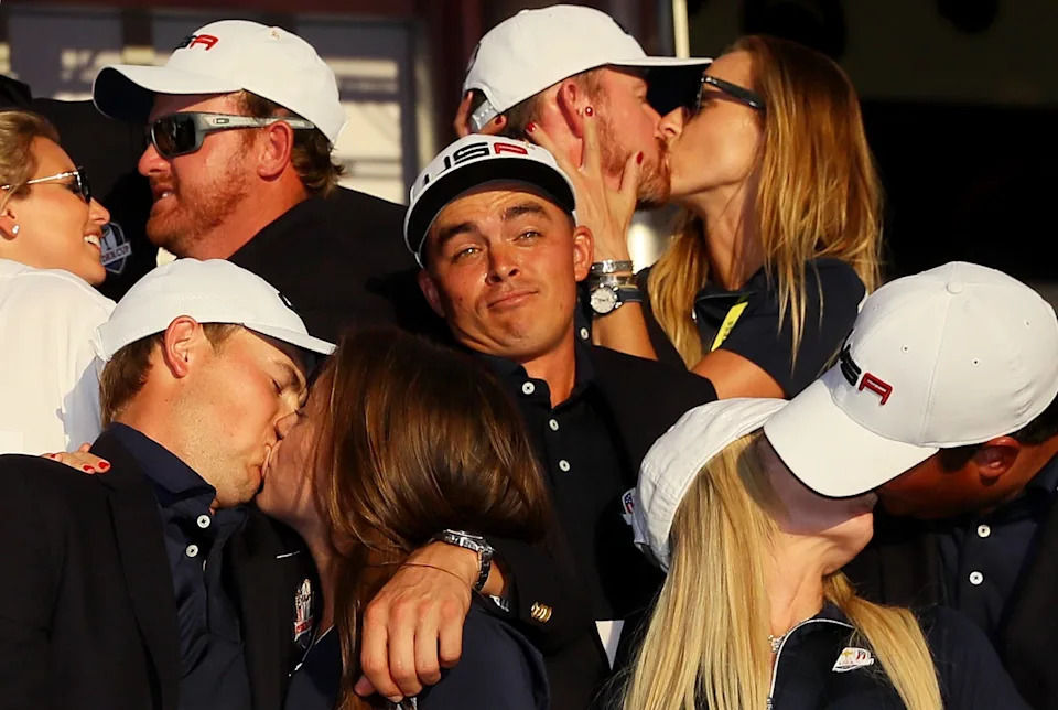 Rickie Fowler looks on as J.B. Holmes, Erica Holmes, Jimmy Walker, Erin Walker, Jordan Spieth, Annie Verret, Justine Reed and Patrick Reed celebrate during singles matches of the 2016 Ryder Cup at Hazeltine National Golf Club on October 2, 2016 in Chaska, Minnesota. (Photo by Andrew Redington/Getty Images)