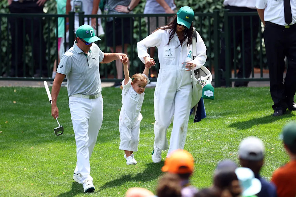 Rickie Fowler of the United States and his wife, Allison Stokke, hold their daughter, Maya, during the Par Three Contest prior to the 2024 Masters Tournament at Augusta National Golf Club on April 10, 2024 in Augusta, Georgia.