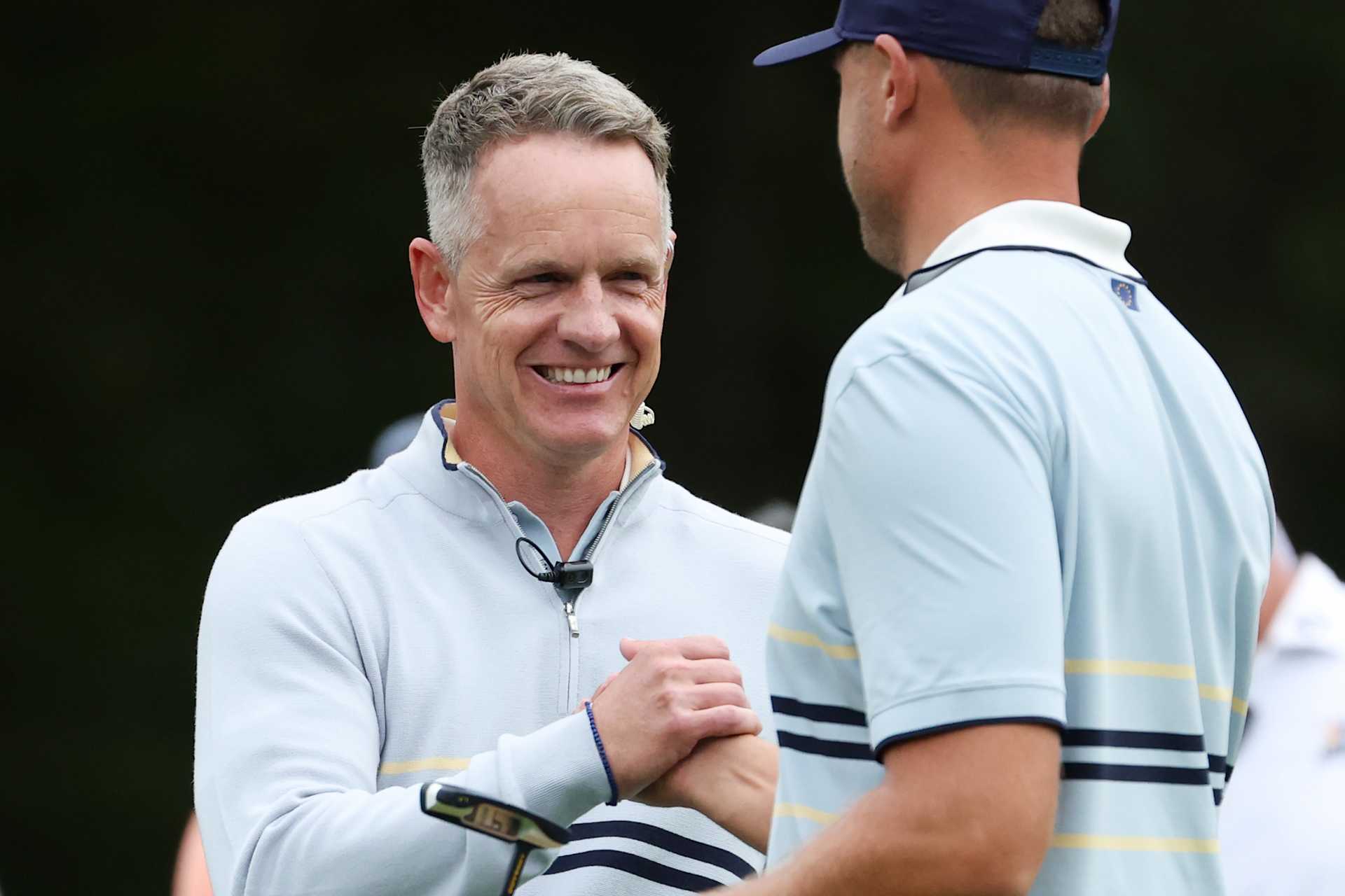FARMINGDALE, NEW YORK - SEPTEMBER 26: Luke Donald, Captain of Team Europe shakes hands with Ludvig Aberg of Team Europe on the seventh green during the Friday morning foursomes matches of the 2025 Ryder Cup at Black Course at Bethpage State Park Golf Course on September 26, 2025 in Farmingdale, New York. (Photo by Jamie Squire/Getty Images)
