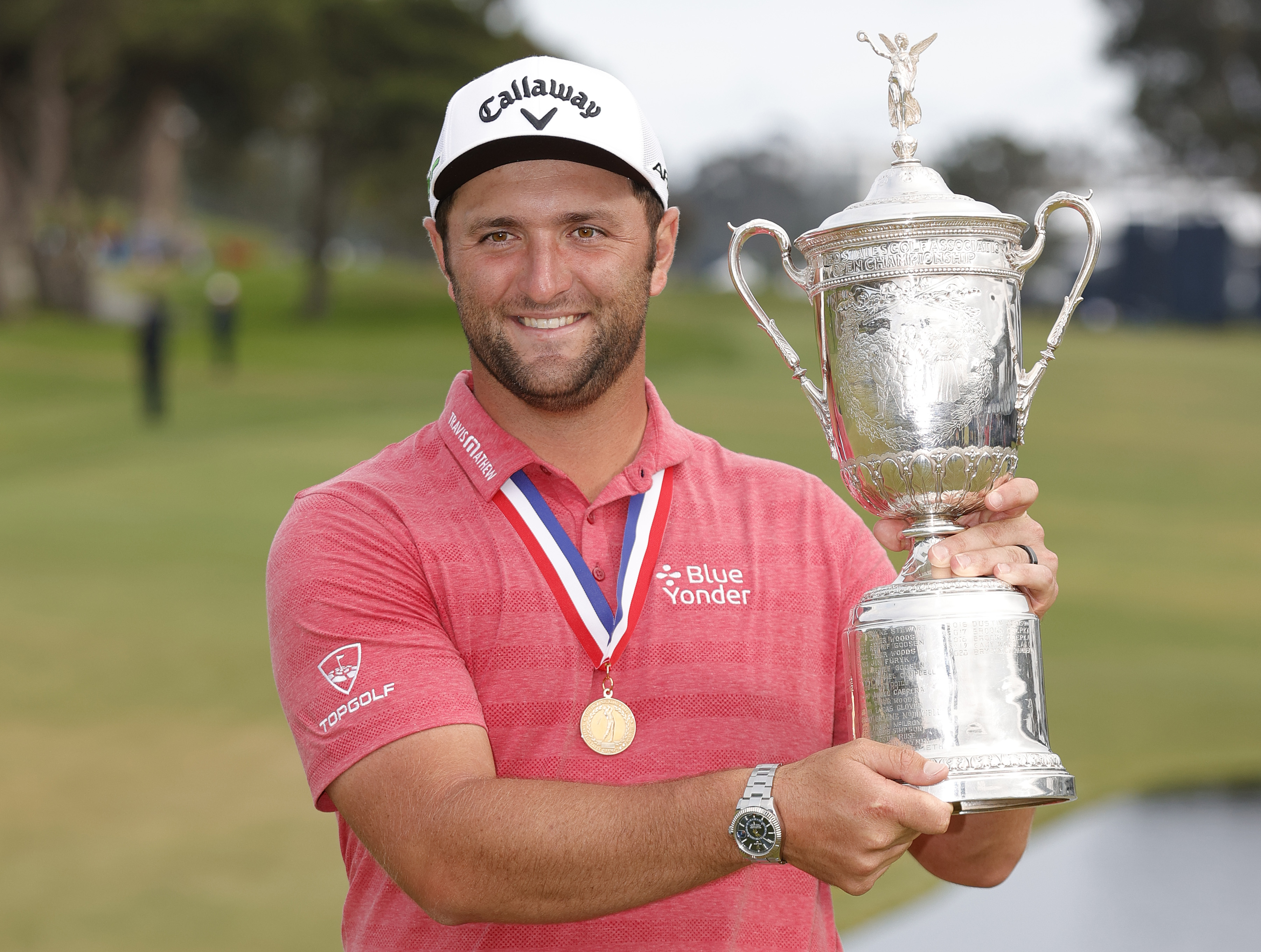 Jon Rahm wins the US Open and poses with the trophy