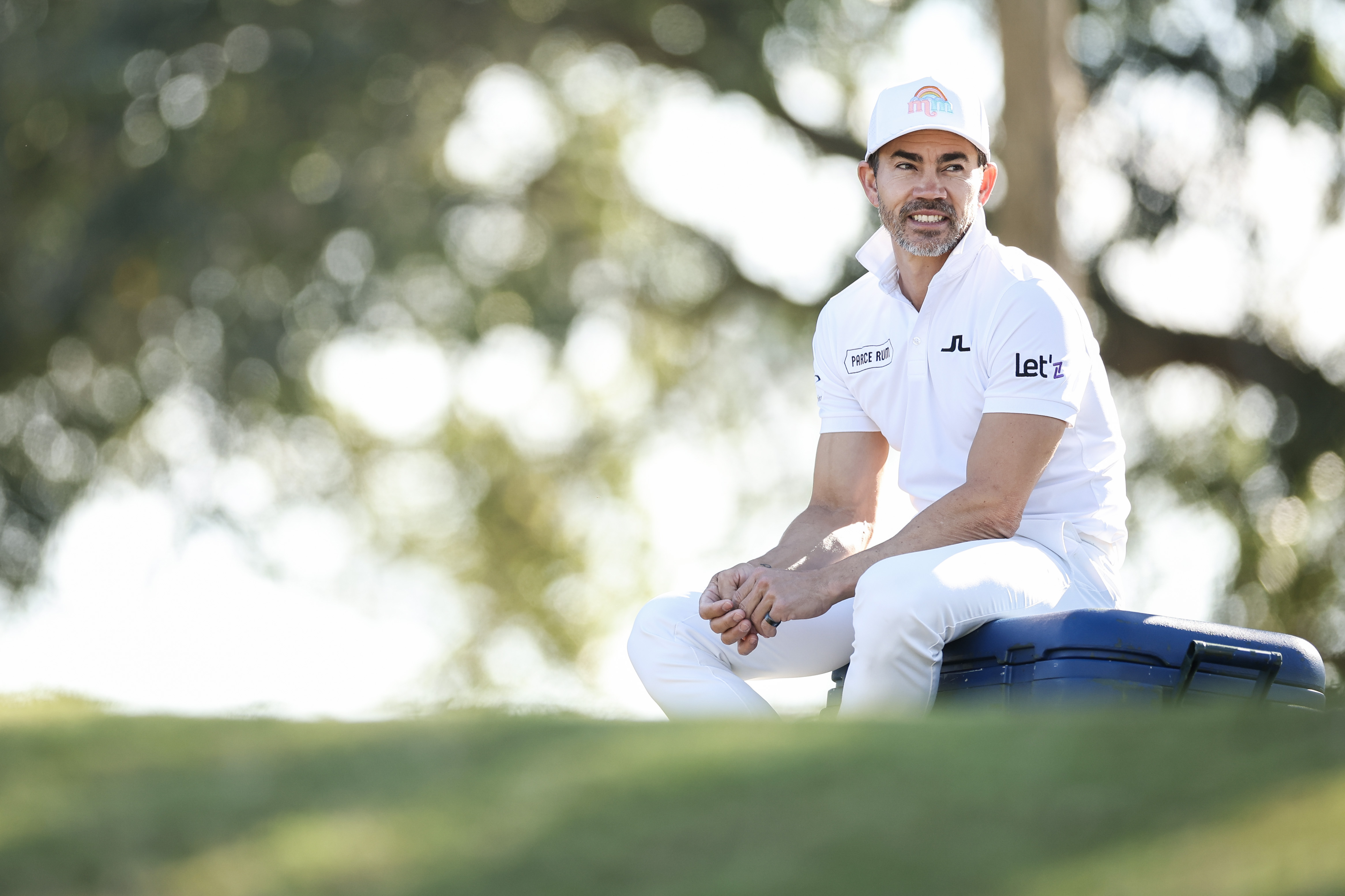 Camilo Villegas sits on his golf bag