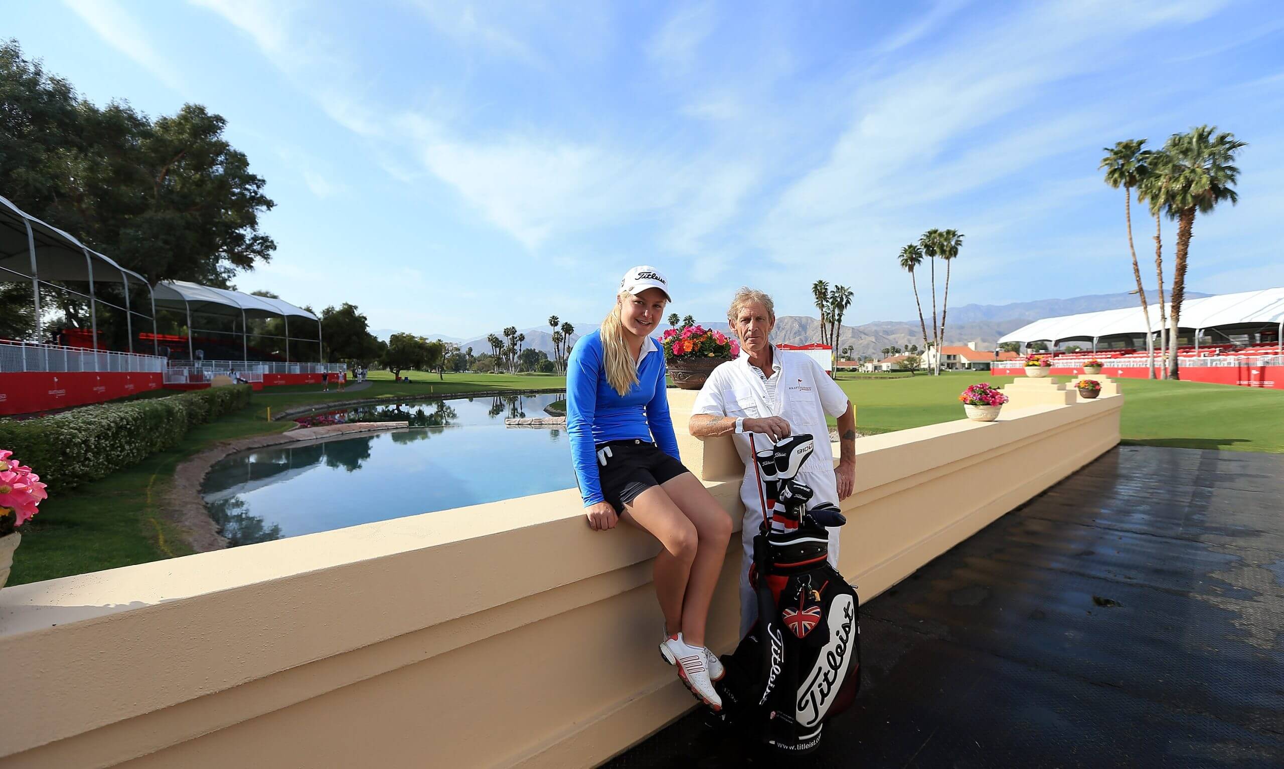 Charley Hull rests on the bridge at the 2012 Curtis Cup, posing for a photo with her father, Dave.