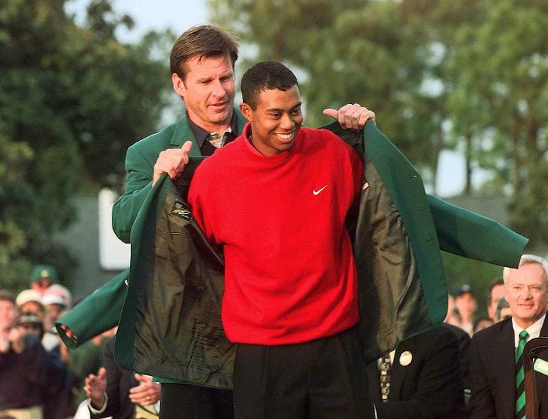 Tiger Woods receives the Masters green jacket for winning the 1997 Masters Tournament from 1996 winner Nick Faldo at Augusta. Woods won the tournament with a record eighteen-under-par. Photograph: Jeff Haynes/AFP via Getty Images