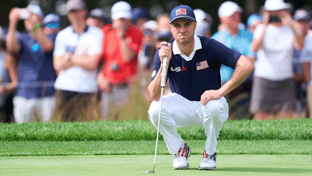 Justin Thomas crouches down behind a putt during day two of the 2025 Ryder Cup at Bethpage Black