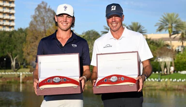 Matt Kuchar, right, and his son Cameron Kuchar hold the championship belts after winning the PNC Championship golf tournament, Sunday, Dec. 21, 2025, in Orlando, Fla. (AP Photo/Phelan M. Ebenhack)