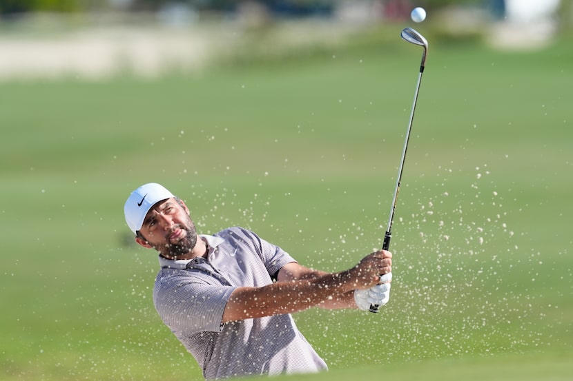 Scottie Scheffler, of the United States, hits from the bunker on the 10th hole during the...