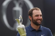 FILE - Scottie Scheffler of the United States holds the Claret Jug trophy as he poses for...