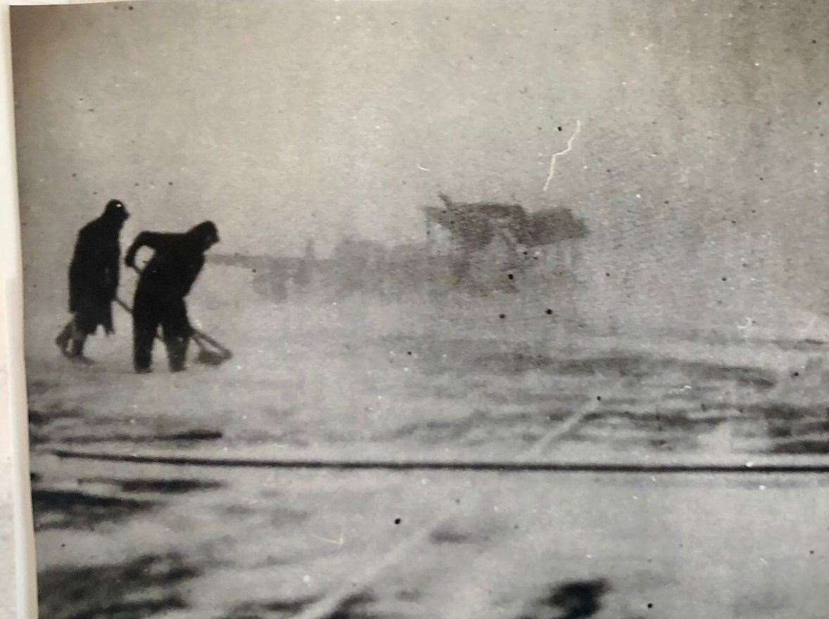 Snow is swept from the deck of the escort carrier on which Archie would have to land