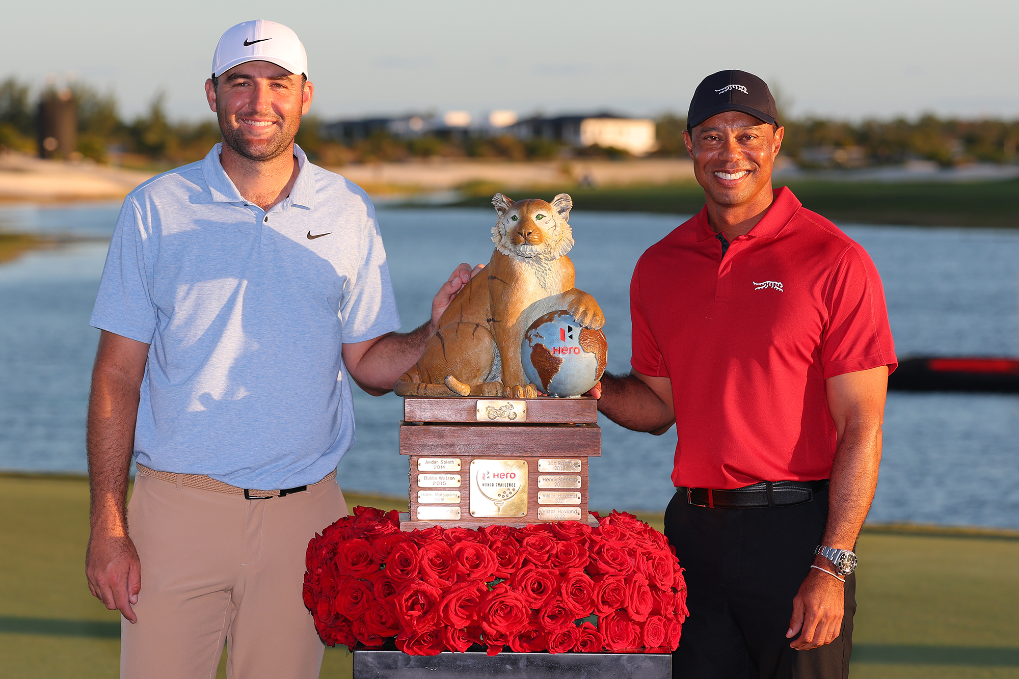 Scottie Scheffler posing with Tiger Woods and the trophy at the Hero World Challenge, a tournament hosted by Woods that Scheffler won in 2024