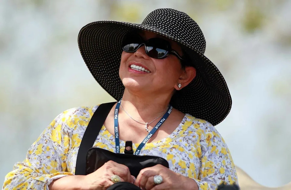 Tiger Wood's mother Kultida Woods, center, watches him play during the first round of the Honda Classic golf tournament in Palm Beach Gardens, Fla., Thursday, March 1, 2012.