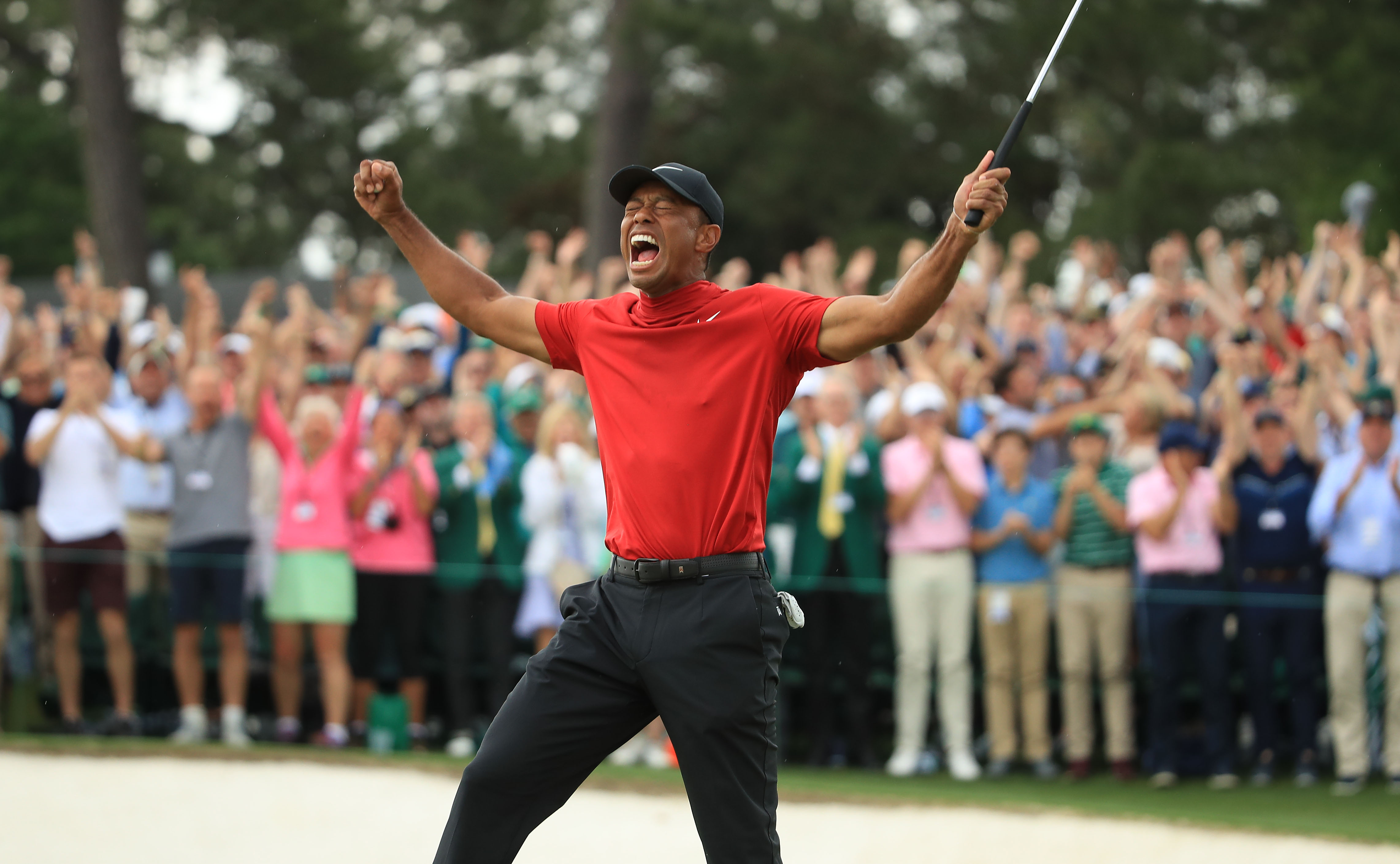 Tiger Woods fist pumps after holing the winning putt at the 2019 Masters