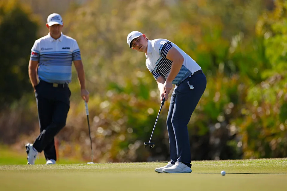 Paddy Harrington watches a putt on the ninth green as his father Padraig Harrington looks on during the second round of the 2024 PNC Championship at Ritz-Carlton Golf Club in Orlando.