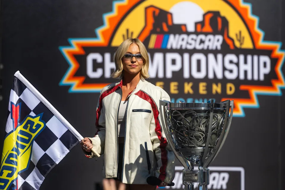 Nov 2, 2025; Avondale, Arizona, USA; Actress Sydney Sweeney brings out the checkered flag prior to the NASCAR Cup Series Championship race at Phoenix Raceway. Mandatory Credit: Mark J. Rebilas-Imagn Images