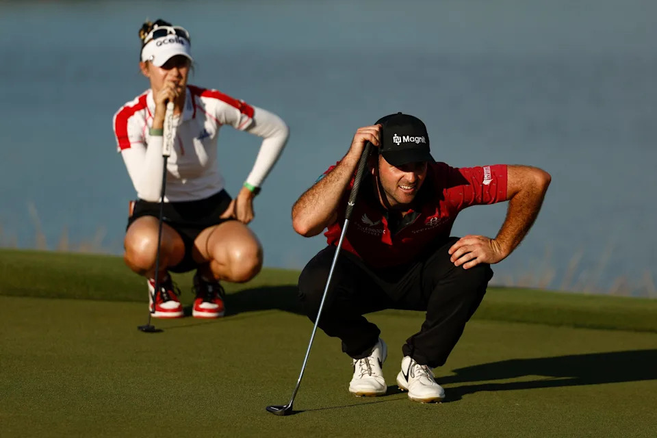 Denny McCarthy and Nelly Korda of the United States line up a putt on the eighteenth green during round one of the QBE Shootout at Tiburon Golf Club on December 09, 2022 in Naples, Florida.