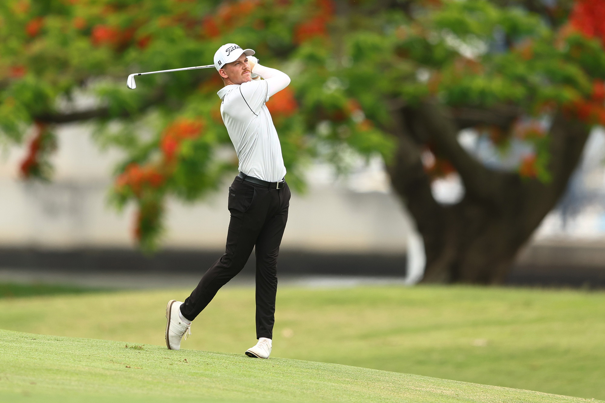 Daniel Hillier in the finish position with an iron