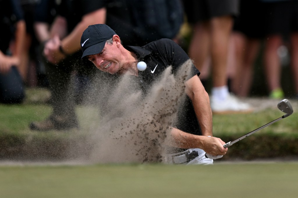 Rory McIlroy hits out of a bunker during the second round of the Australian Open golf tournament at the Royal Melbourne Golf Club in Melbourne on December 5, 2025. 