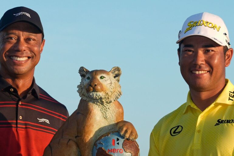 Hideki Matsuyama, of Japan, right, poses for a photo with golf legend Tiger Woods after winning the Hero World Challenge