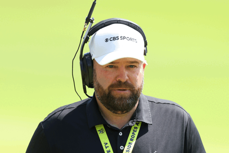 A headshot of Colt Knost wearing a white CBS Sports cap and radio headset during 2024