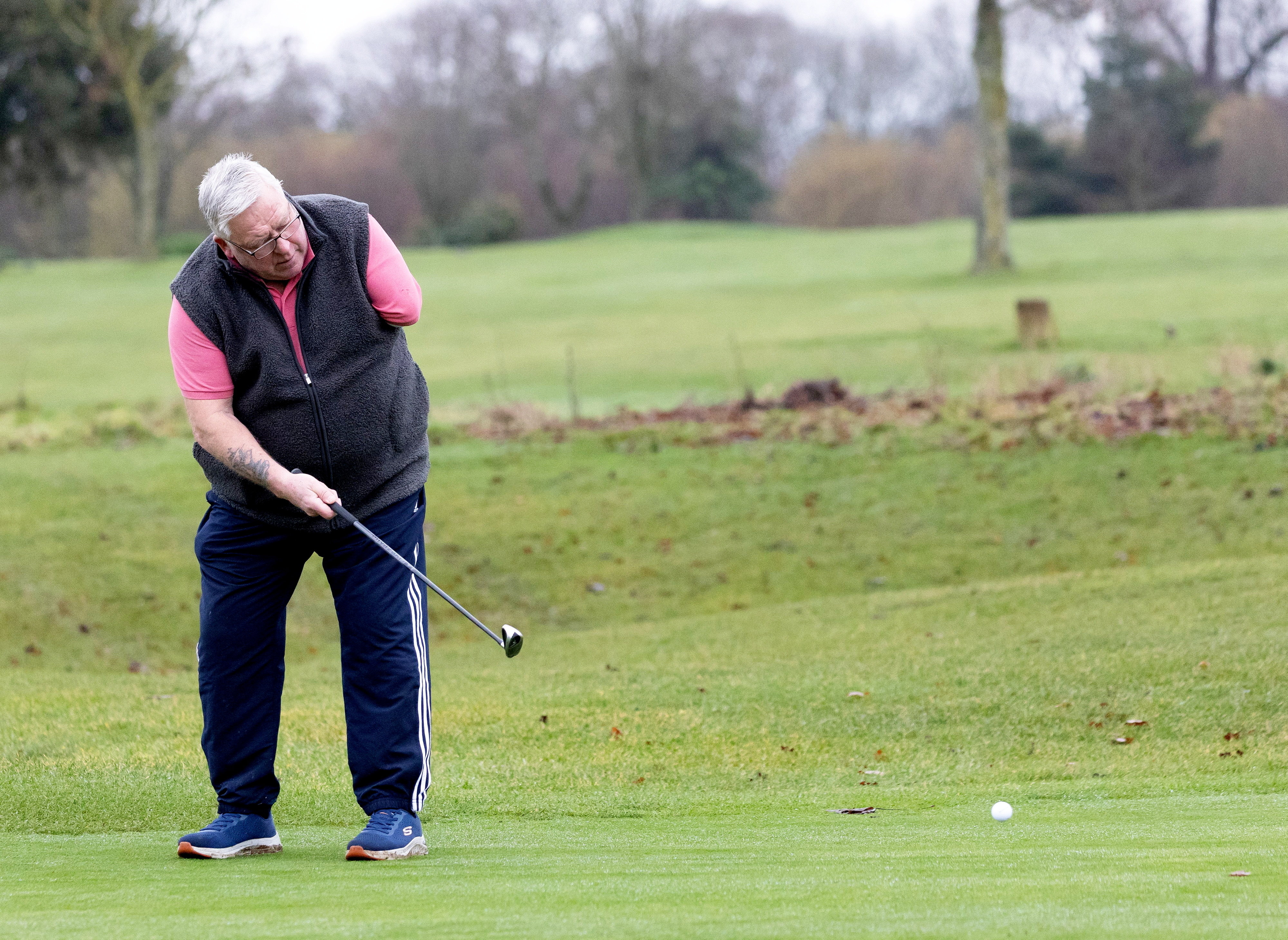 Patrick Duke, a disabled golfer with one arm, is pictured mid-swing on a golf course.