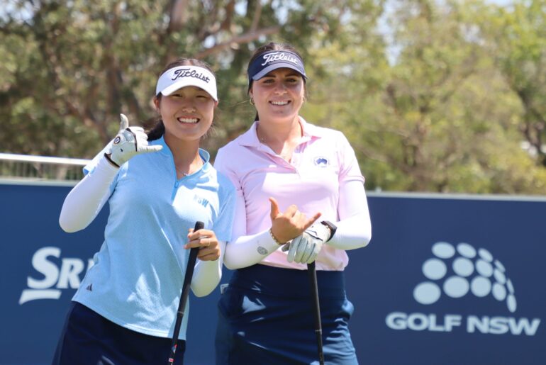 A picture of Camilla Kim and Lara Thomsen holding their hands up smiling