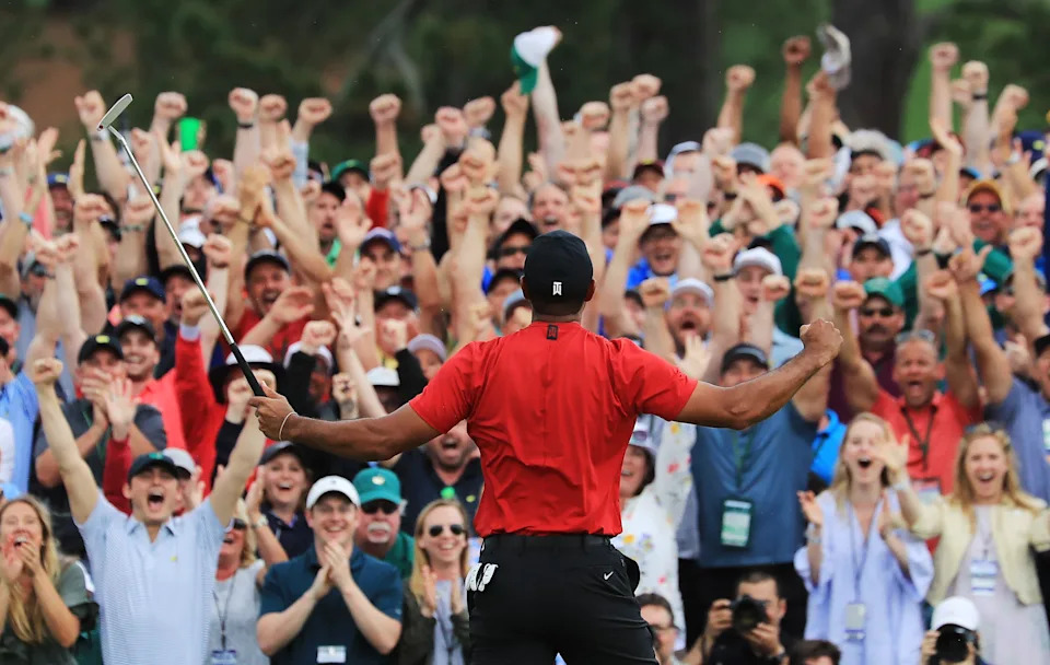 AUGUSTA, GEORGIA - APRIL 14: Patrons cheer as Tiger Woods of the United States celebrates after sinking his putt on the 18th green to win during the final round of the Masters at Augusta National Golf Club on April 14, 2019 in Augusta, Georgia. (Photo by David Cannon/Getty Images)