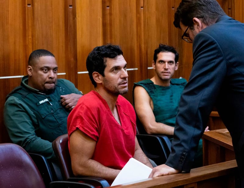 Oren Alexander, 37, center, and his twin brother, Alon, center-right, speak to their attorney Joel Denaro during their bond hearing at the Richard E. Gerstein Justice Building on Thursday, Dec. 12, 2024, in Miami, Fla. Oren, alongside his twin brother Alon Alexander, have been charged with multiple state and federal crimes, including sex trafficking and rape.