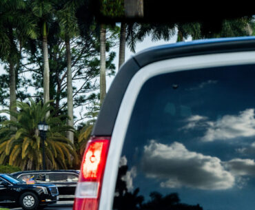 President Donald Trump departs Trump International Golf Club in the presidential limousine, known a...