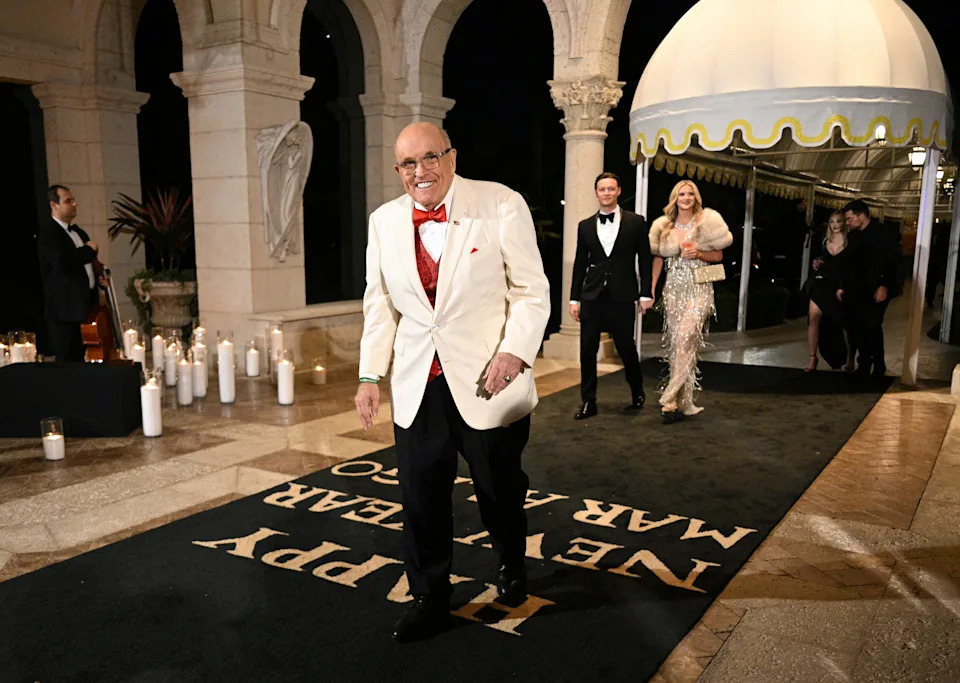 Rudy Giuliani arrives at Donald and Melania's New Year's Eve party at Mar-a-Lago. / JIM WATSON / AFP via Getty Images