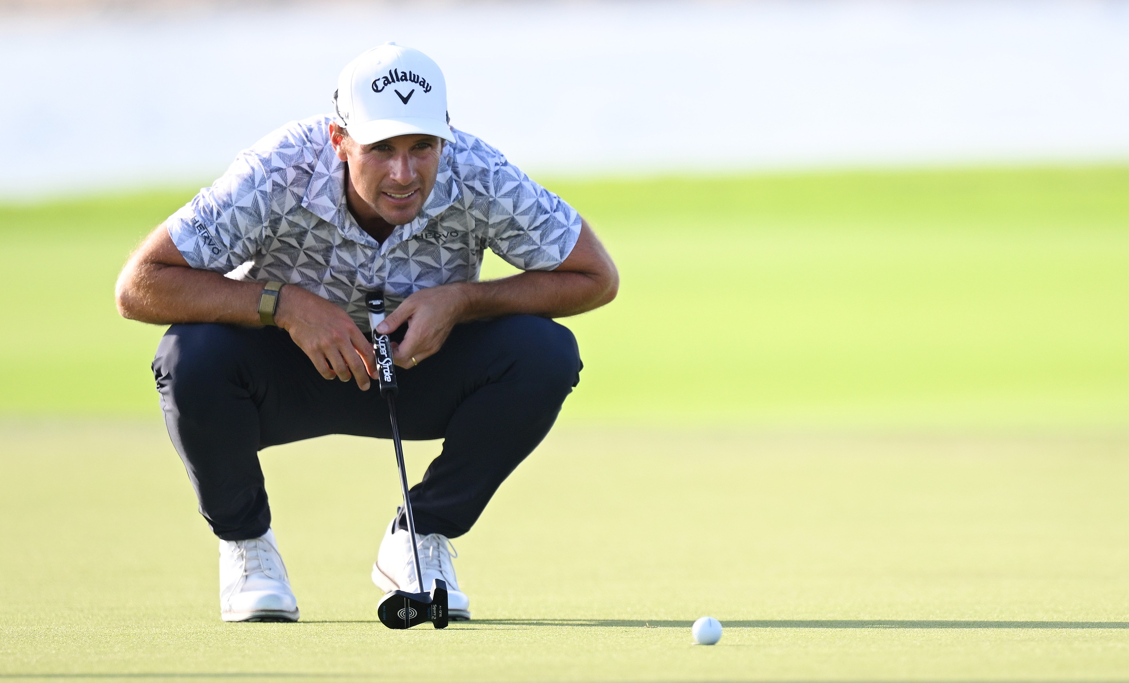 Andrea Pavan lines up a putt on the 15th green at the Qatar Masters.
