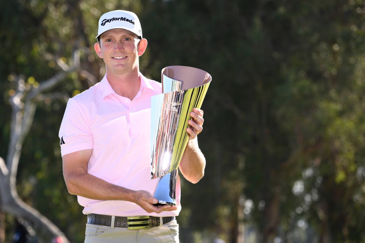 Jacob Bridgeman of the United States celebrates with the trophy on the 18th green after his win during the final round of The Genesis Invitational 2026 at Riviera Country Club on February 22, 2026 in Pacific Palisades, California. 
