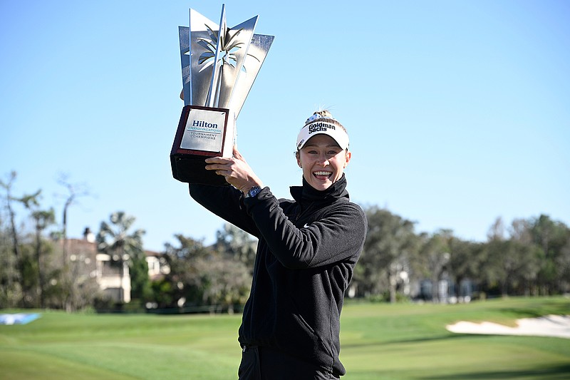 AP photo by Phelan M. Ebenhack / Nelly Korda poses with the championship trophy Sunday after winning the LPGA Tour's Tournament of Champions at Lake Nona Golf & Country Club in Orlando, Fla.