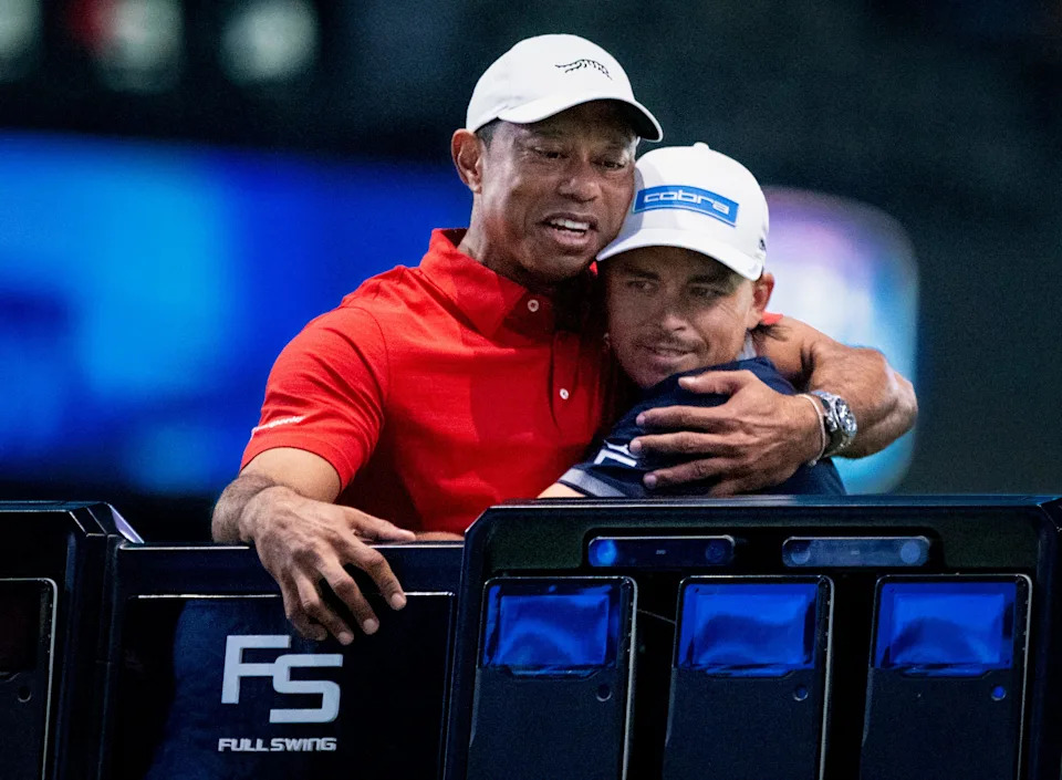 Tiger Woods of Jupiter Links hugs Rickie Fowler before a TGL match against New York Golf Club at SoFi Center on January 13, 2026, in Palm Beach Gardens, Florida.