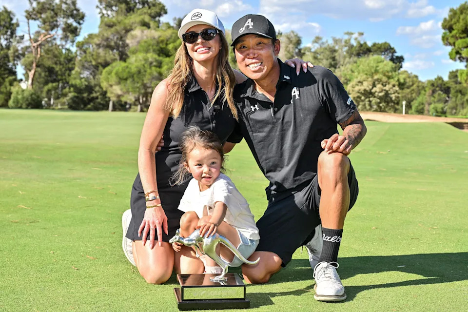 4Aces GC player Anthony Kim from the US (R) celebrates with his wife Emily and his daughter Isabella after he won the LIV Golf Adelaide tournament at The Grange Golf Club in Adelaide on February 15, 2026.