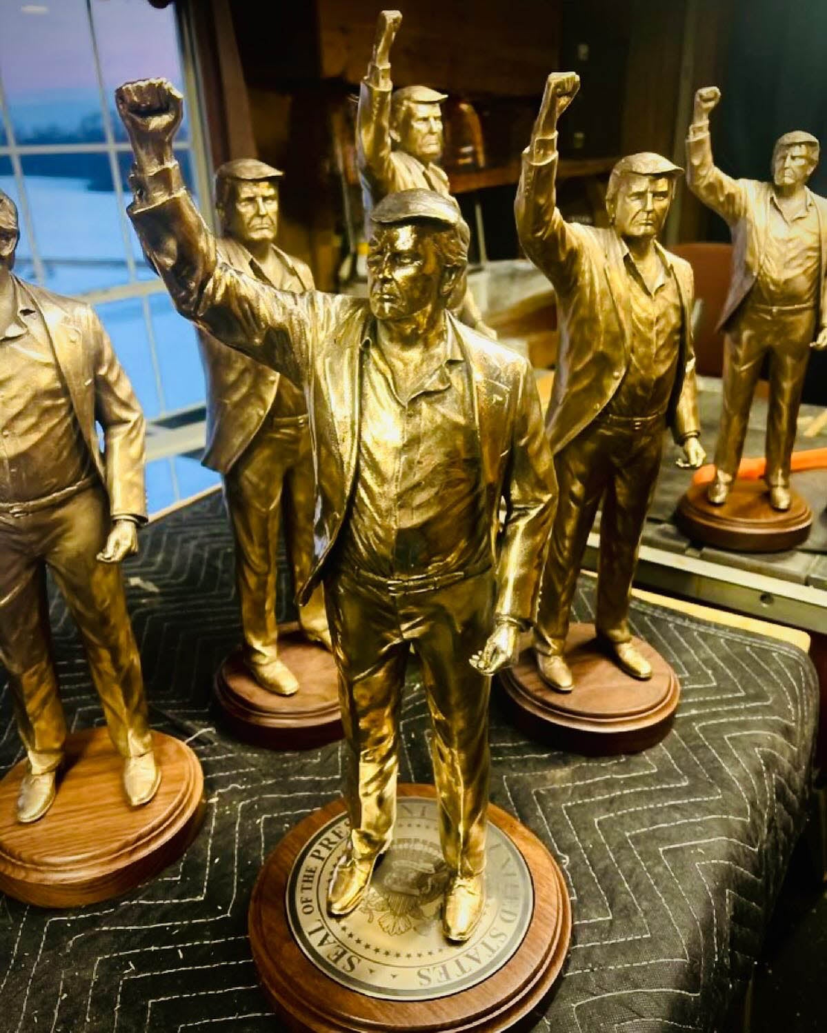 Small models of the planned Trump statue are depicted in this photograph from the sculptor’s Instagram page