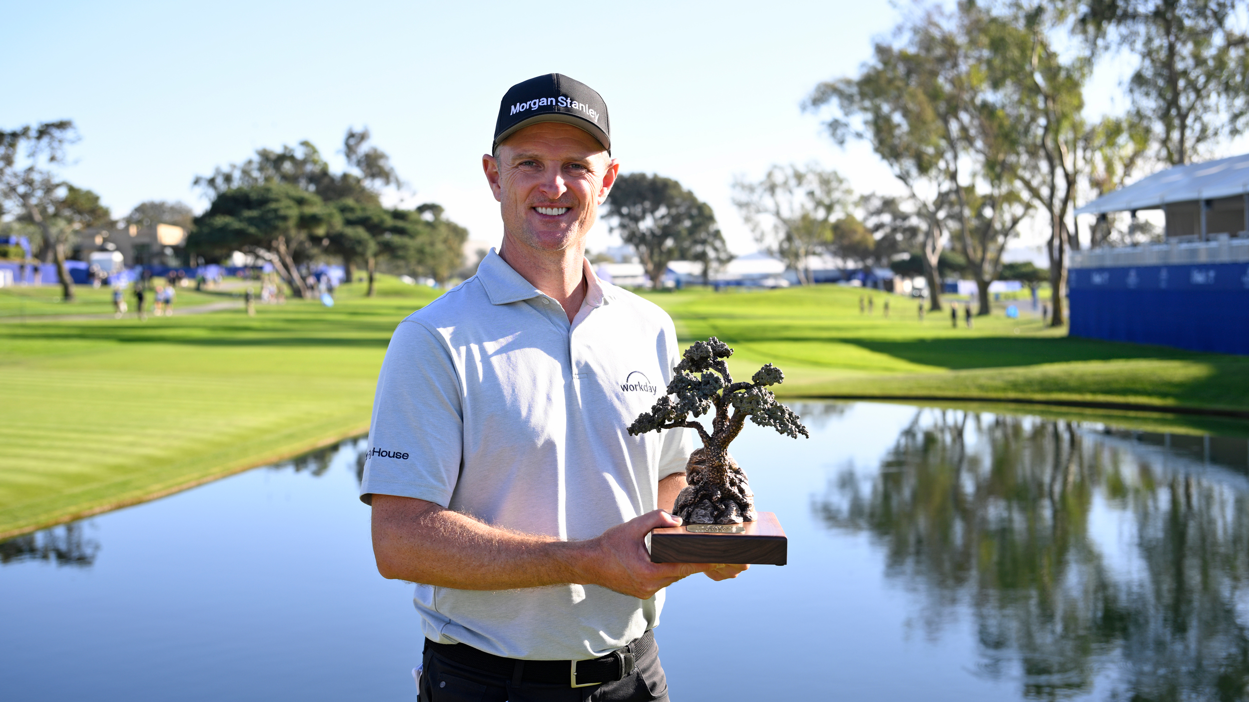 Justin Rose poses with the Farmers Insurance Open trophy in 2026
