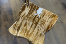 My client wanted a gift for an employee who was retiring. I started with a quilted live edge base, then added logos for the company. On the face is a piece of wood from U of O that had been painted both yellow and green throughout the years and had weathered down.