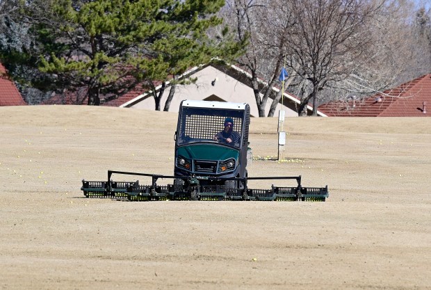 Mike Connelly, an Olde Course employee, drives a range picker to up balls on the driving range Tuesday, Feb 17, 2026, at the golf course in Loveland. After Thursday all golf carts will be banned from the course including the range picker becuase of the dry conditions on the course. (Jenny Sparks/Loveland Reporter-Herald)