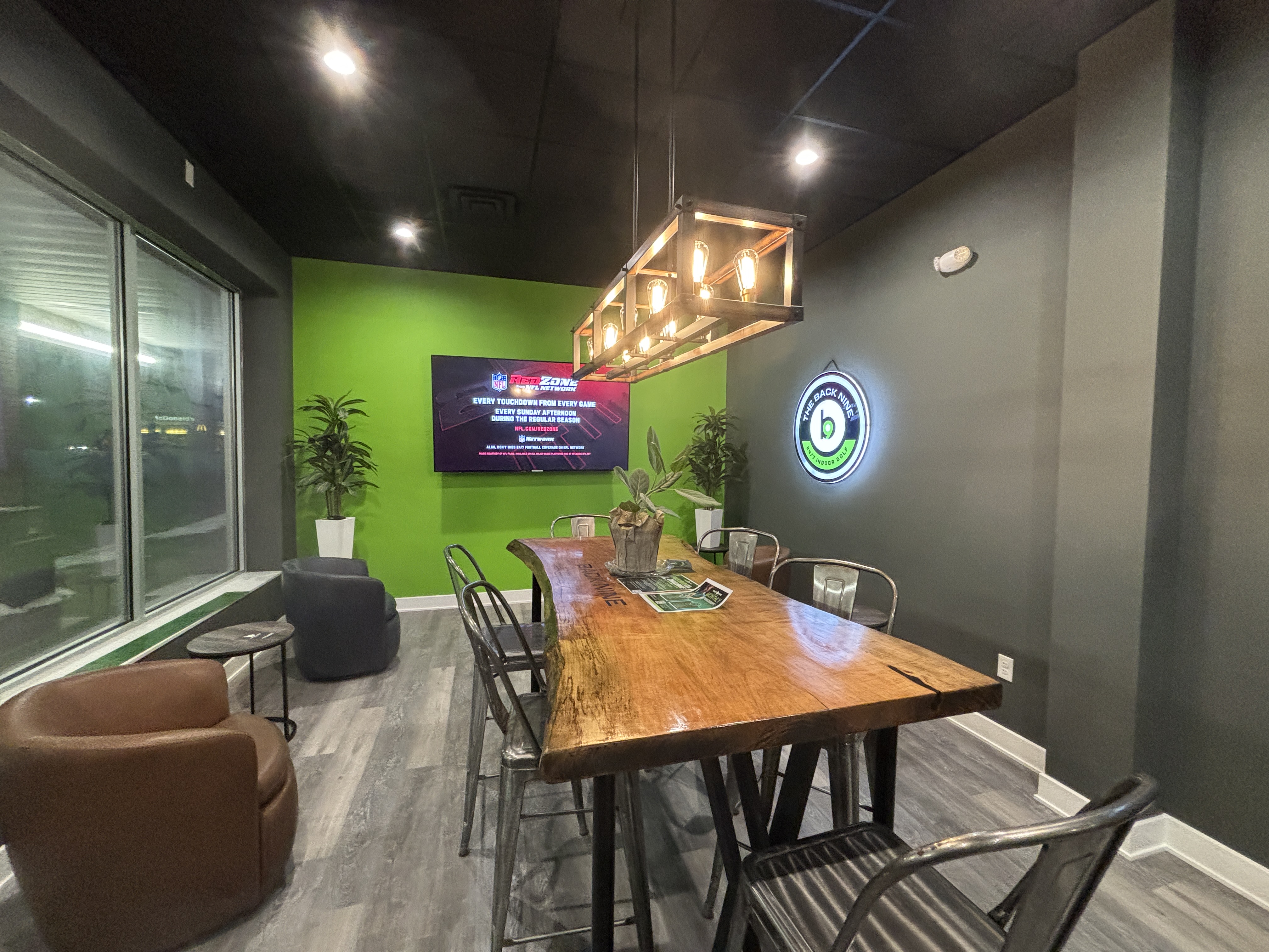 Chairs, a table and a TV are set up near...