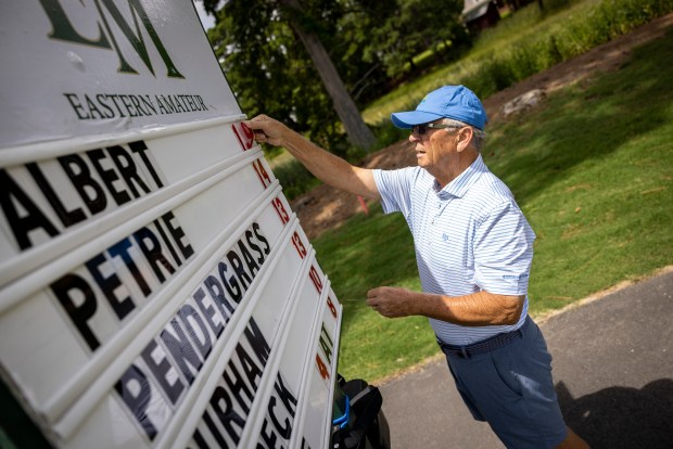 Volunteer Glen Morris updates Jake Albert's score on the leaderboard during the final round of the 68th Eastern Amateur at Elizabeth Manor Golf and Country Club in Portsmouth, Virginia, on Aug. 2, 2025. (Billy Schuerman / The Virginian-Pilot)