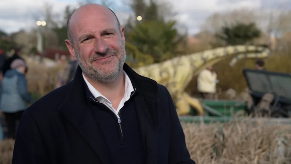 Stephen Brown, chief operating officer of Adventure Leisure which operates Mr Mulligan's Dino Golf in Tonbridge, Kent. Stephen is stood on the course, which is blurred into the background.