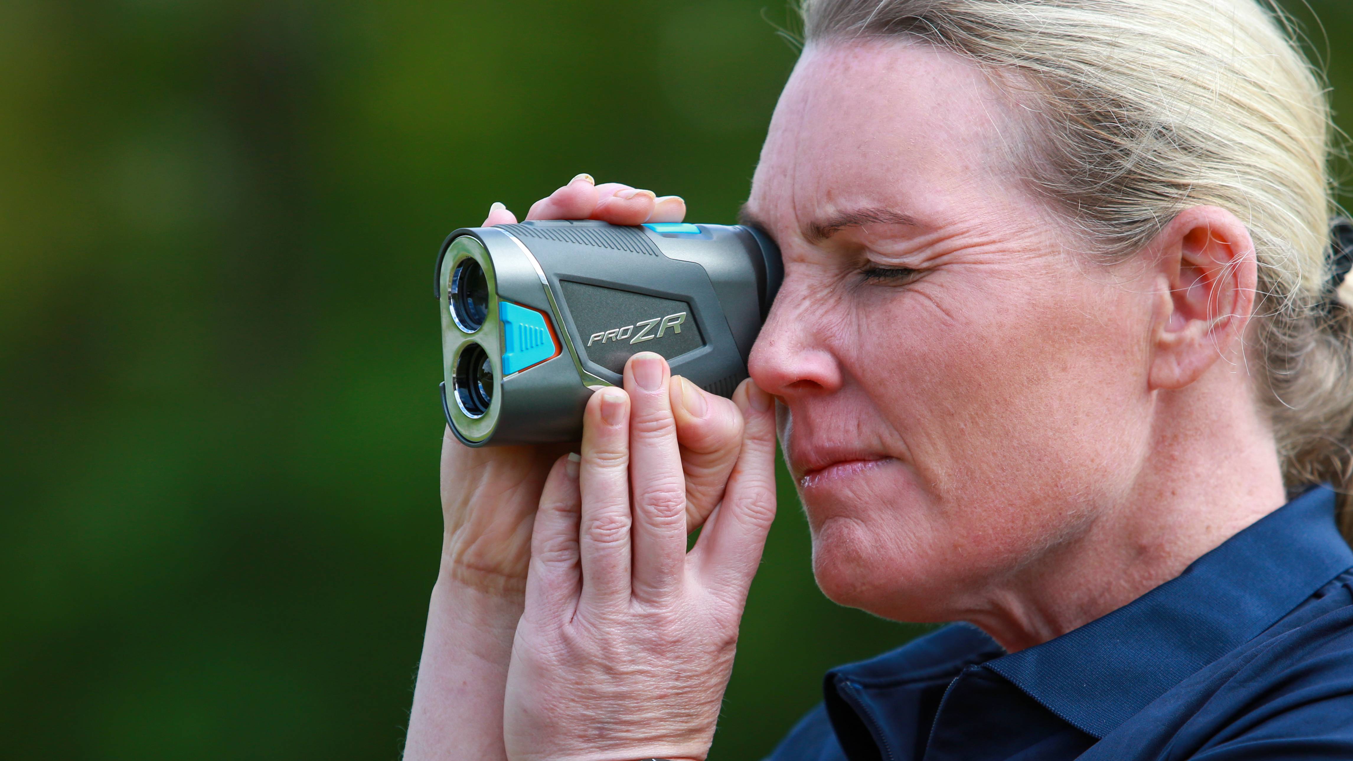 Carly Cummins using a laser rangefinder
