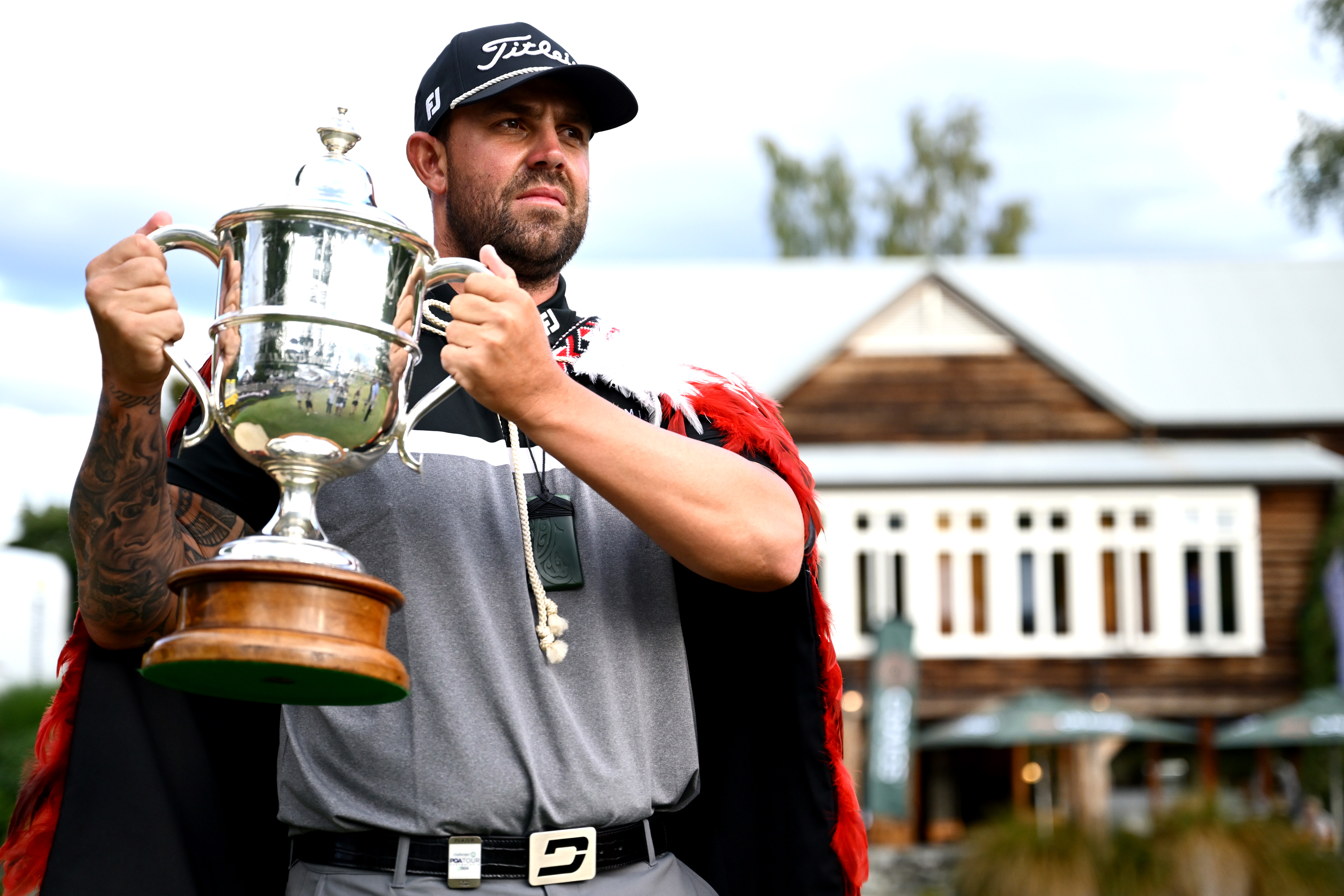 Ryan Peake holds the New Zealand Open trophy