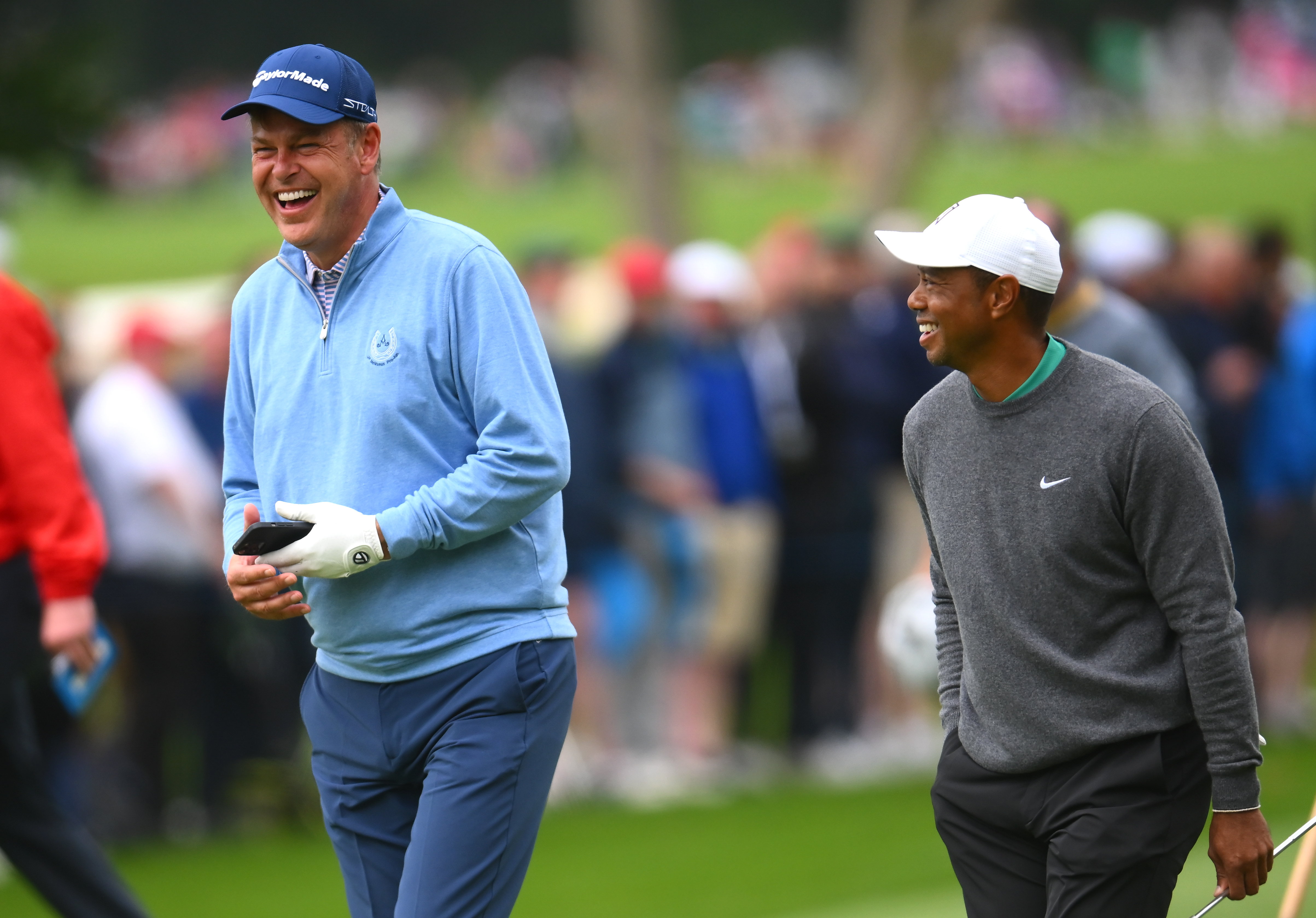 Peter Jones and Tiger Woods walk alongside each other