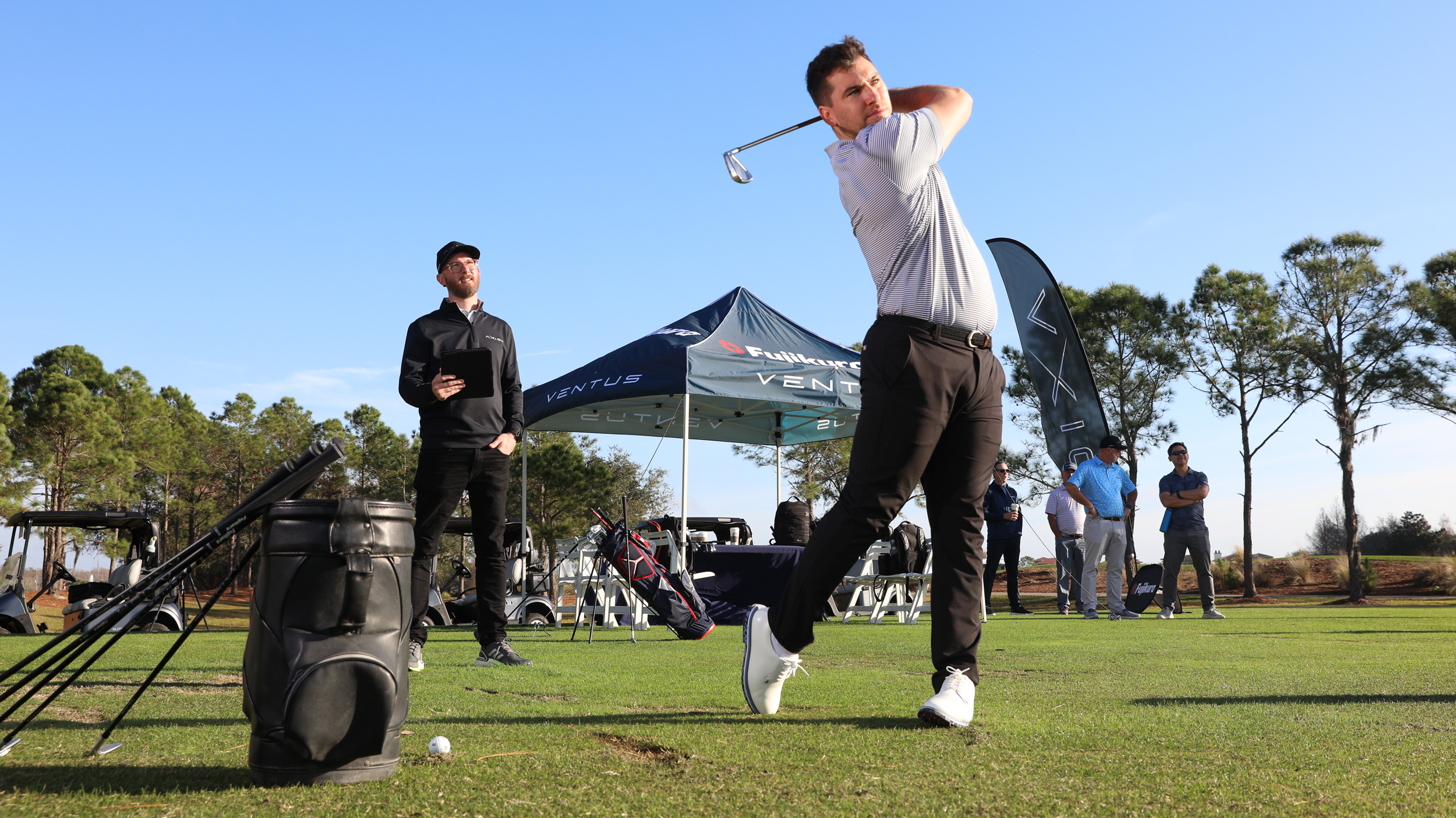 A golfer going through the fitting process for the Fujikura Axiom iron shafts