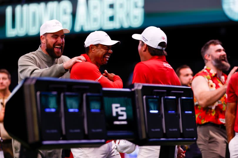 Travis Kelce laughs with Tiger Woods at SoFi Center
